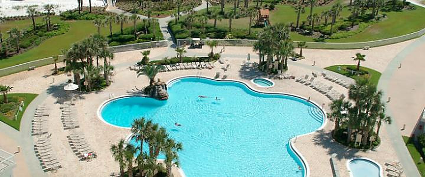 Aerial view of the pool grounds and palm planting at Silver Shells Resort, Destin