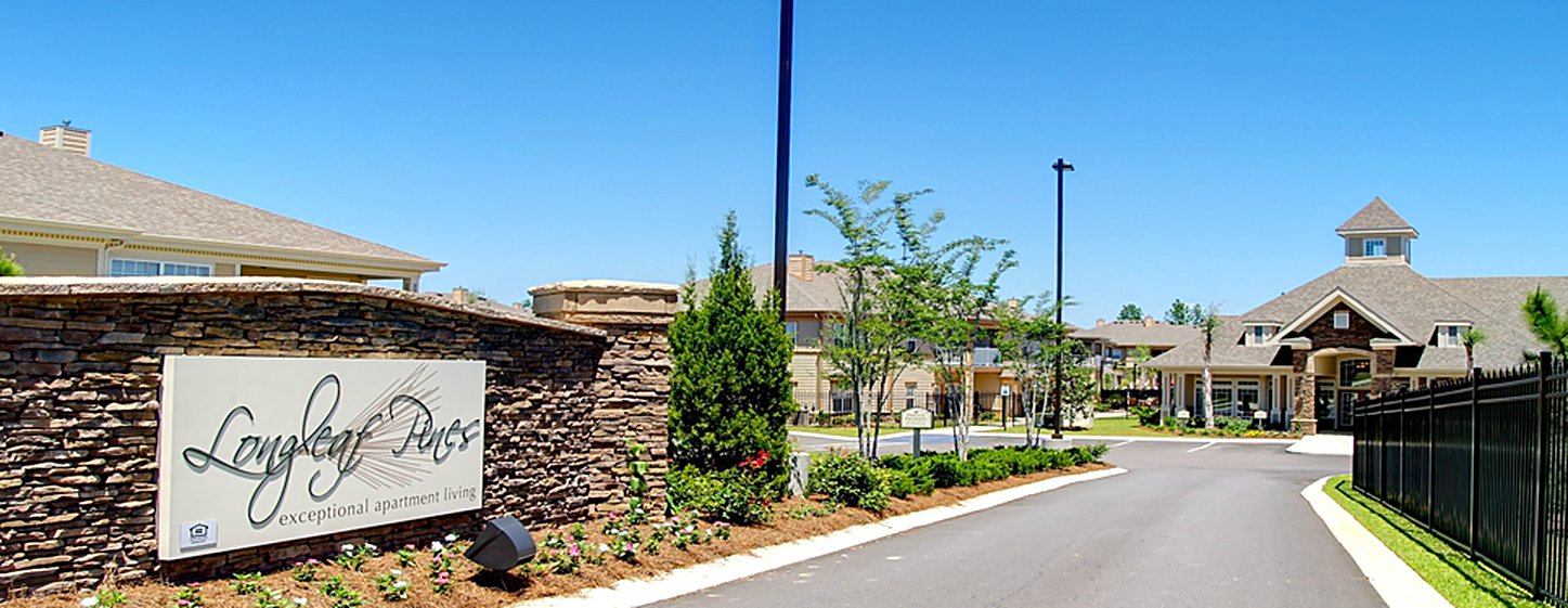 The stacked-stone entrance monument and planting at Longleaf Pines Apartments, Mobile